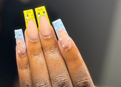 Unique nail art by Nat Thee Nailtech in Pensacola, Florida, featuring vibrant yellow and blue designs.