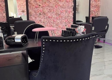 Elegant manicure station at Divine Touch, Wolverhampton, England, GB, featuring plush chairs and floral decor.