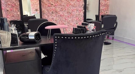 Elegant manicure station at Divine Touch, Wolverhampton, England, GB, featuring plush chairs and floral decor.