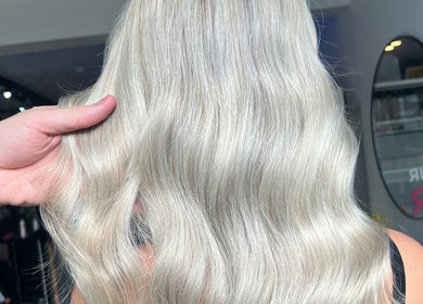 Elegant blonde hair styled at Painted by Will, Harrogate, England, GB, showcasing a polished, wavy finish.