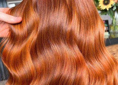 Vibrant auburn hair styling at Blended Hair Collective, Harrogate, England, GB, highlighting glossy waves.