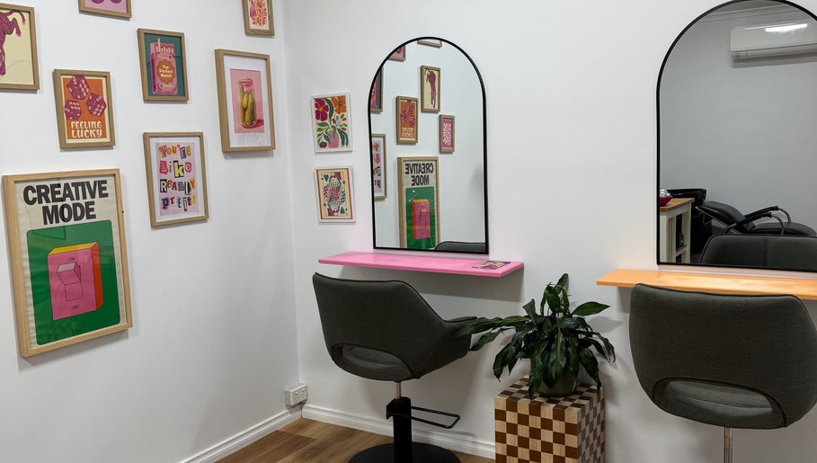 Chic salon interior at JH Social, Nichols Point, Victoria, AU, featuring modern chairs and vibrant art decor.