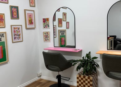 Chic salon interior at JH Social, Nichols Point, Victoria, AU, featuring modern chairs and vibrant art decor.
