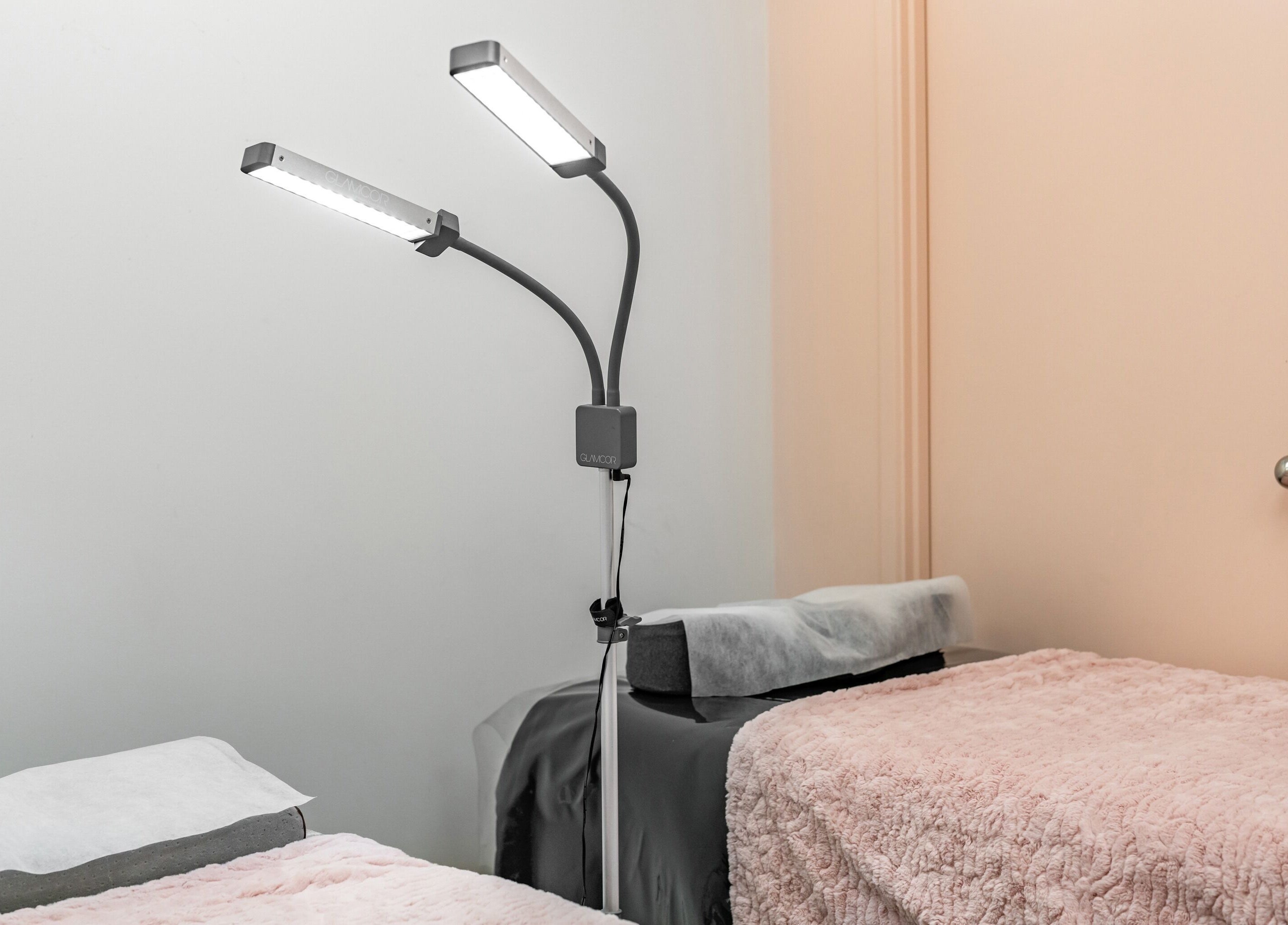 Serene beauty treatment room at Flutter & Co, Auckland, NZ featuring cozy beds and soft lighting.