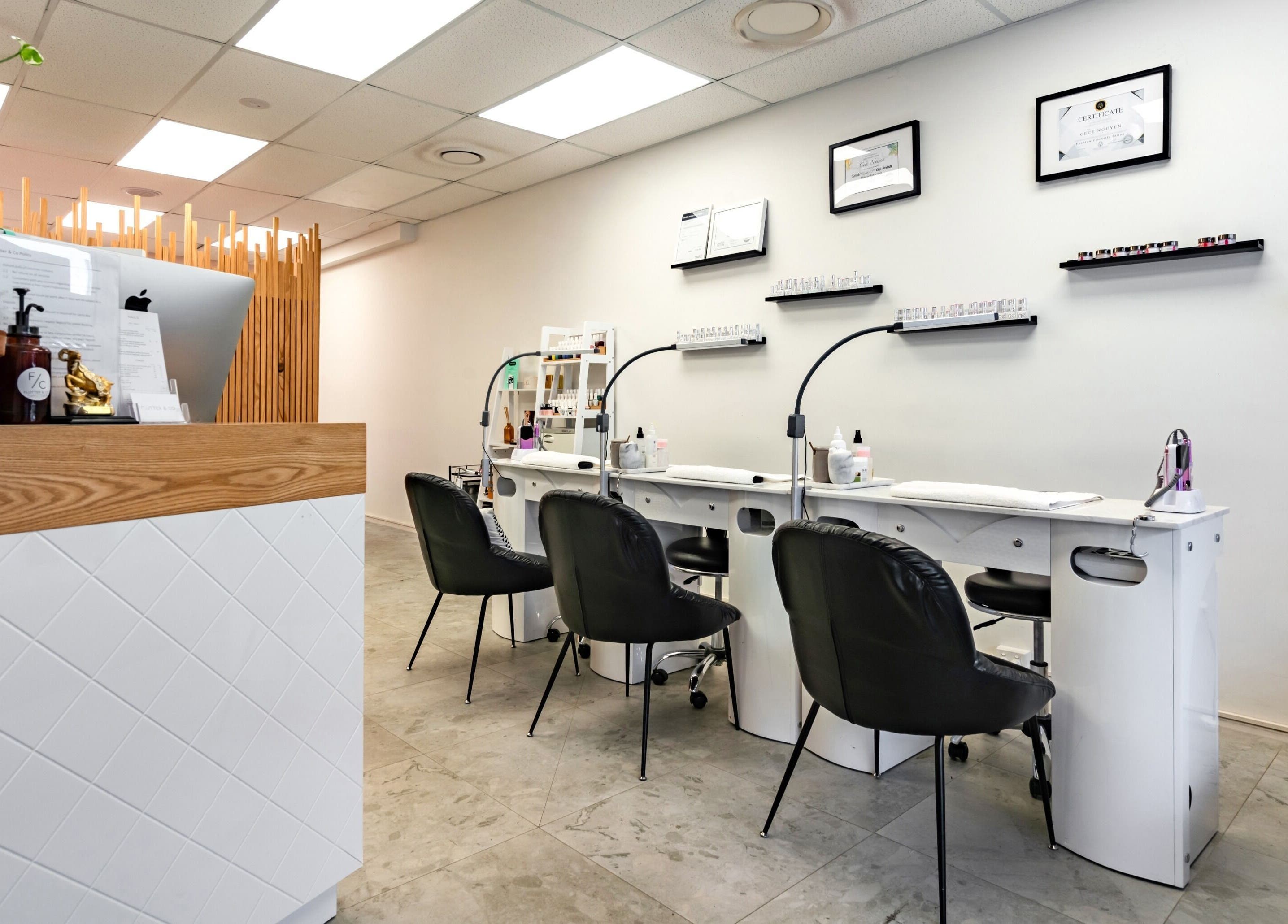 Modern manicure station at Flutter & Co, Auckland, Auckland, NZ, showcasing sleek design and cozy seating.