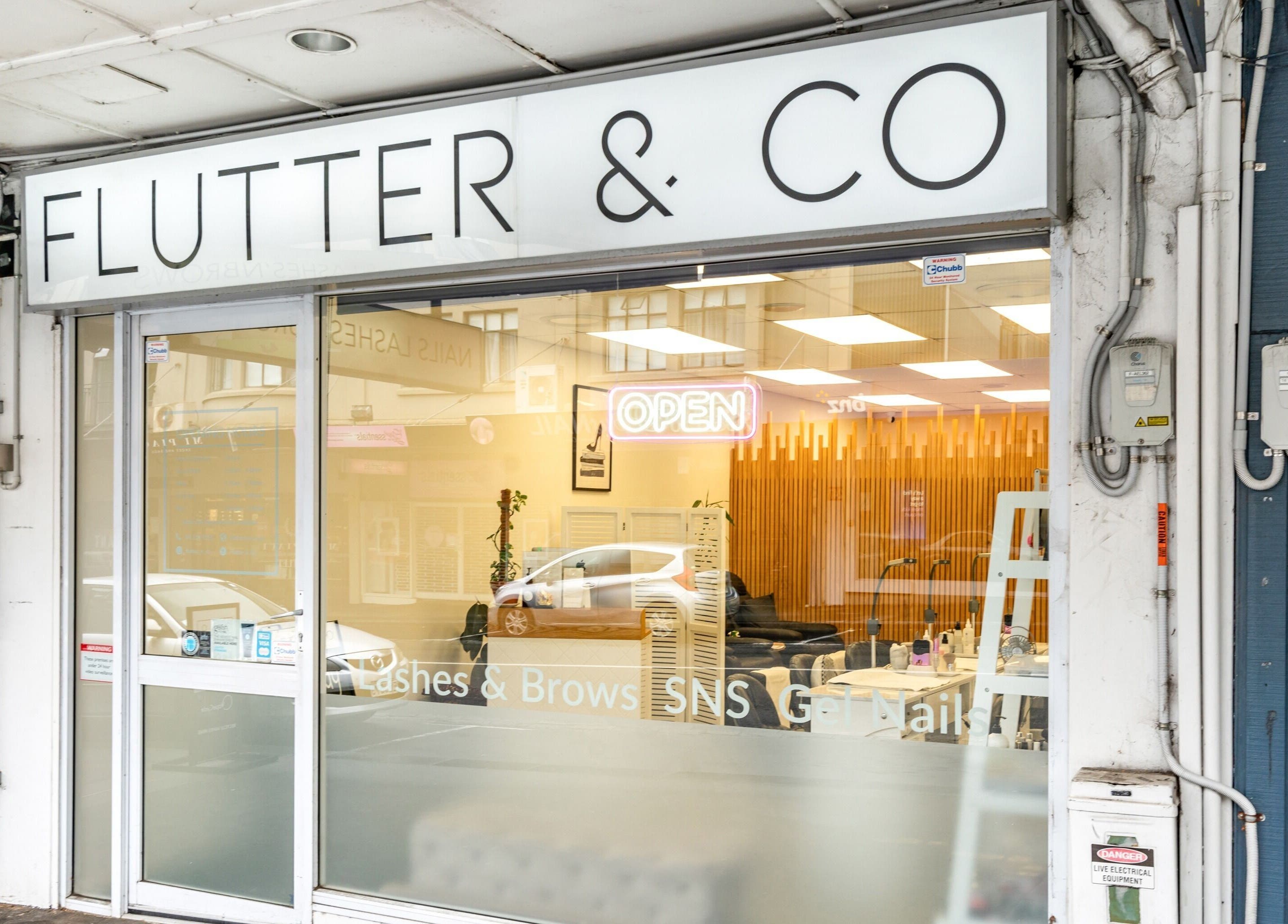 Front view of Flutter & Co beauty salon in Auckland, NZ showcasing a welcoming open sign.