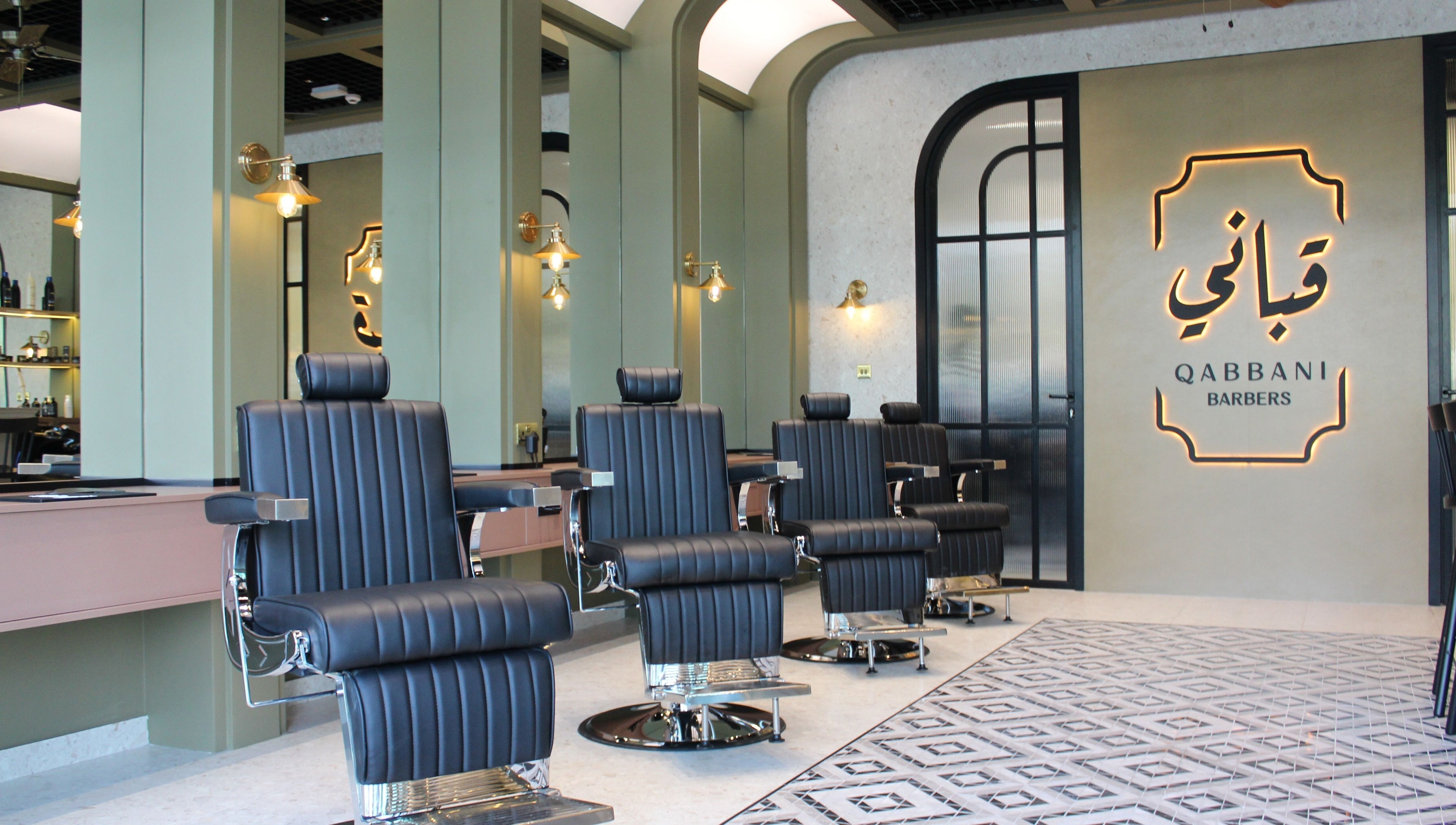 Elegant interior of Qabbani Barbers in Dubai, Dubai, AE featuring modern barber chairs and stylish design.