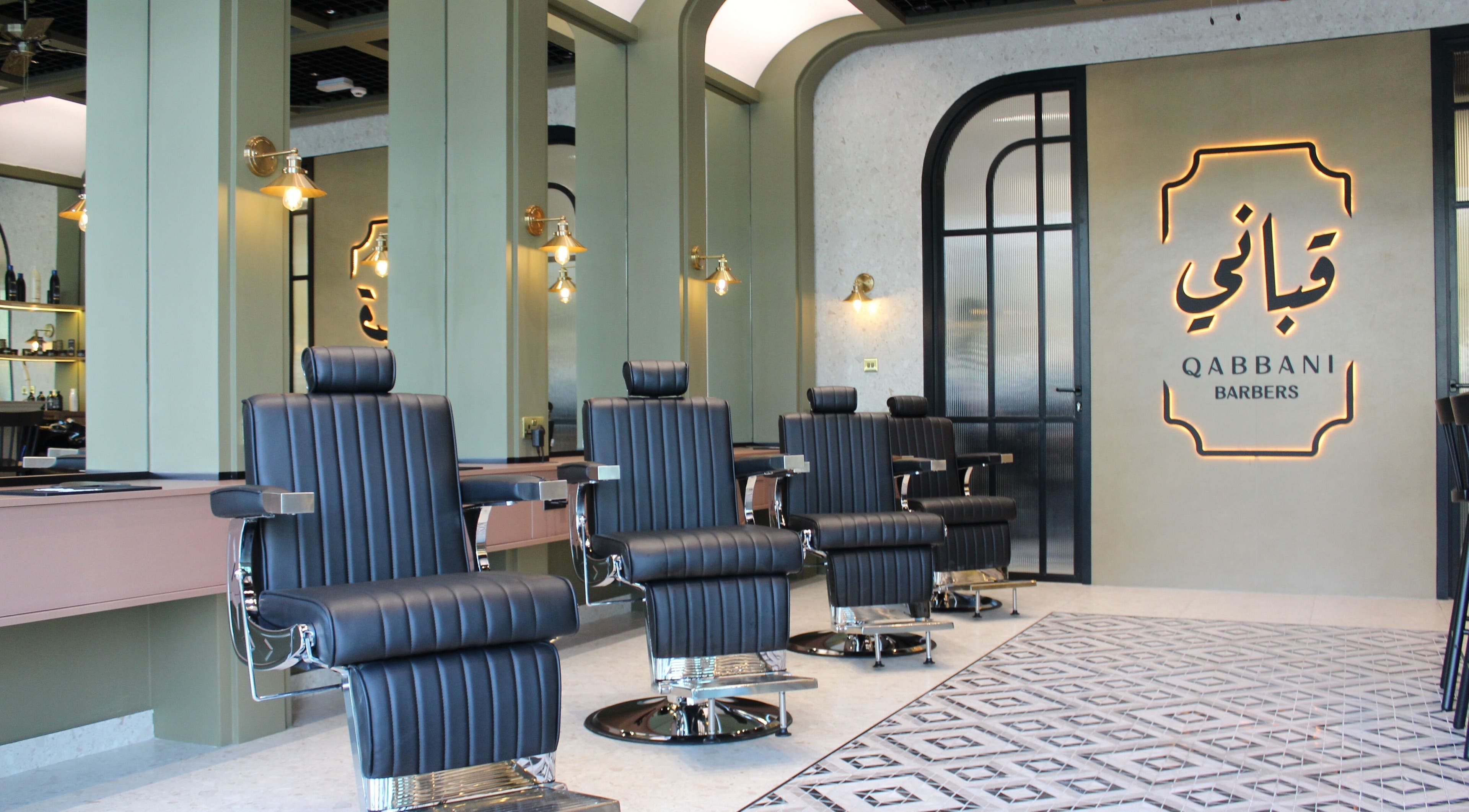 Elegant interior of Qabbani Barbers in Dubai, Dubai, AE featuring modern barber chairs and stylish design.