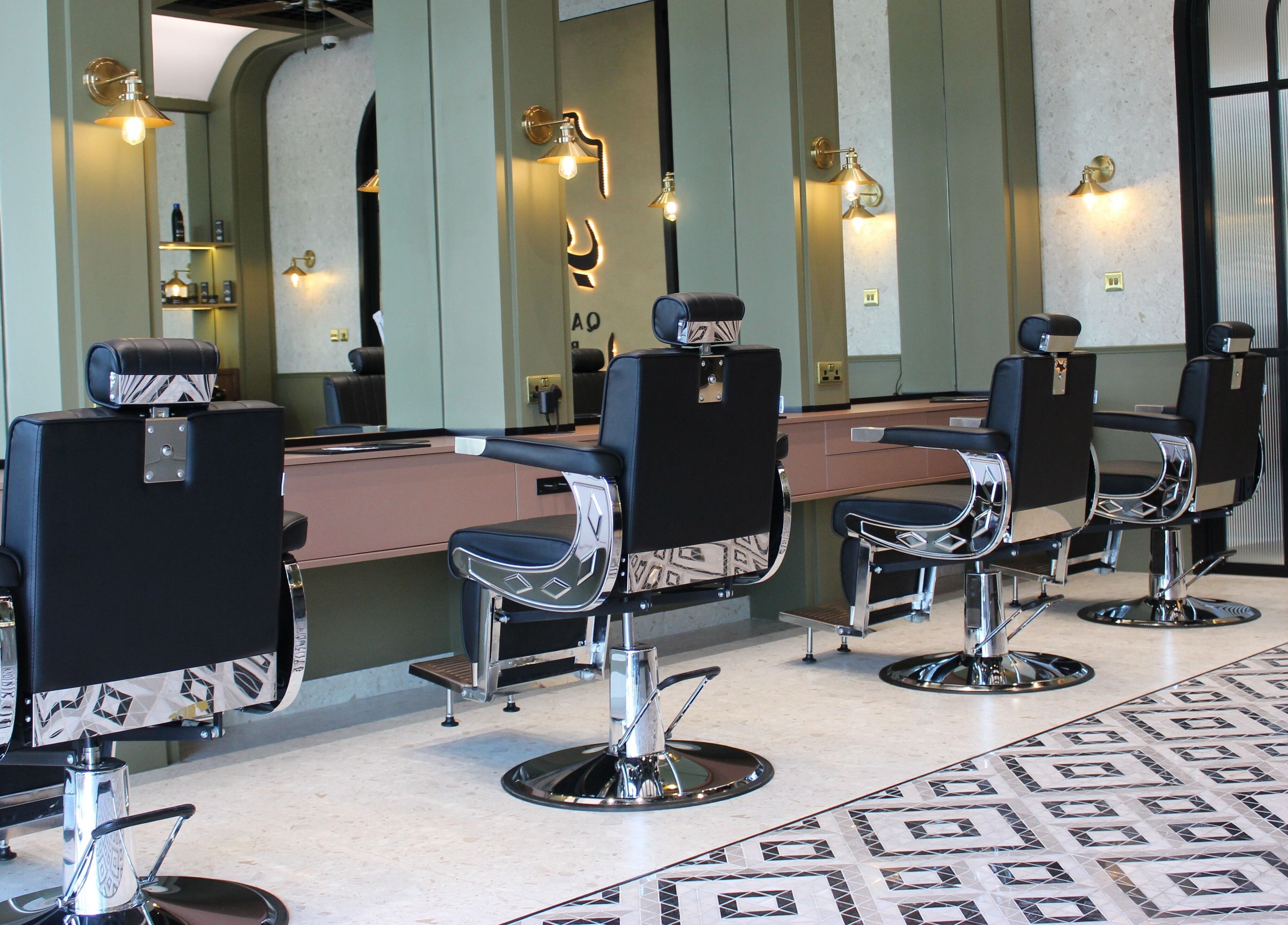 Modern barber chairs at Qabbani Barbers, Dubai, Dubai, AE, featuring sleek design and comfortable seating.