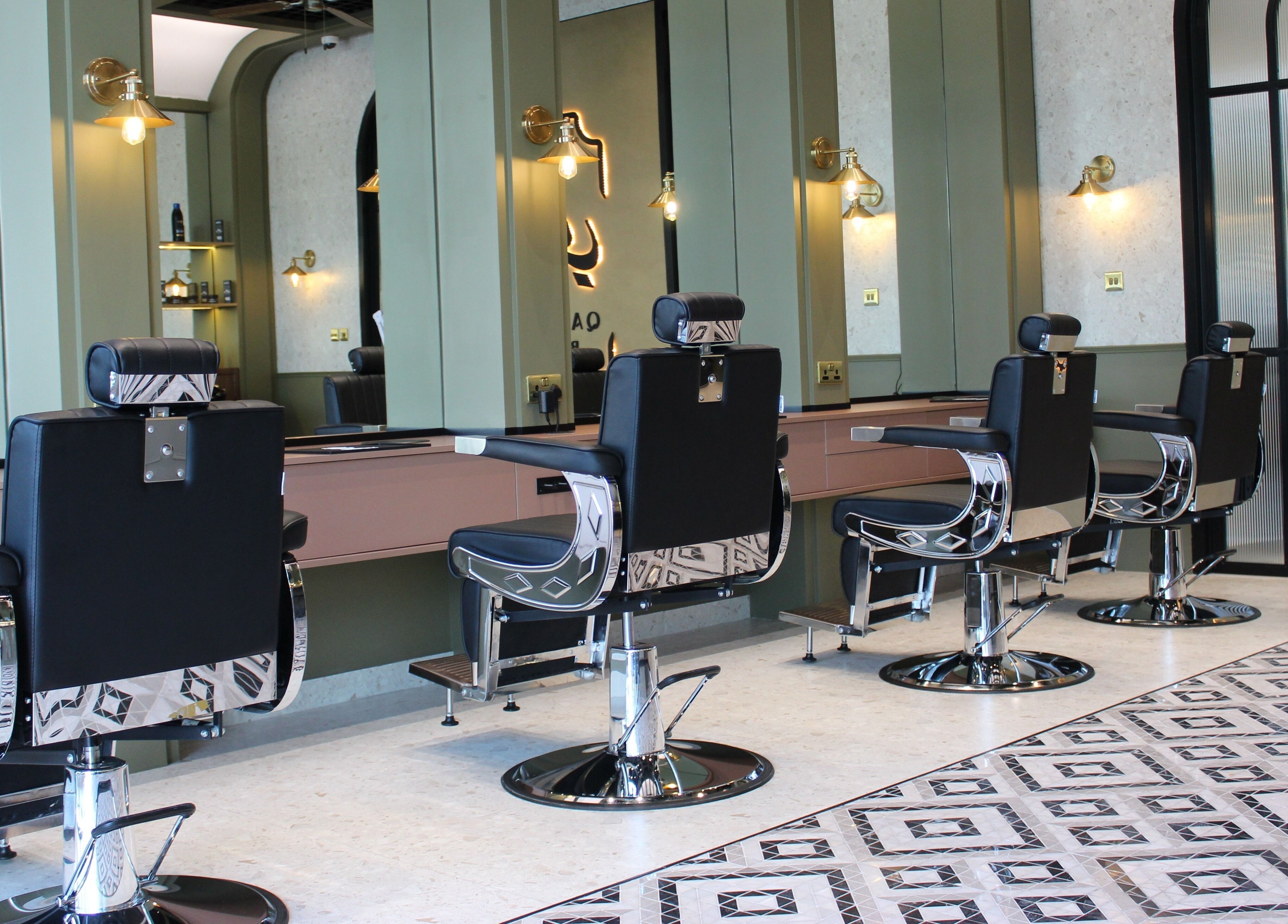 Modern barber chairs at Qabbani Barbers, Dubai, Dubai, AE, featuring sleek design and comfortable seating.