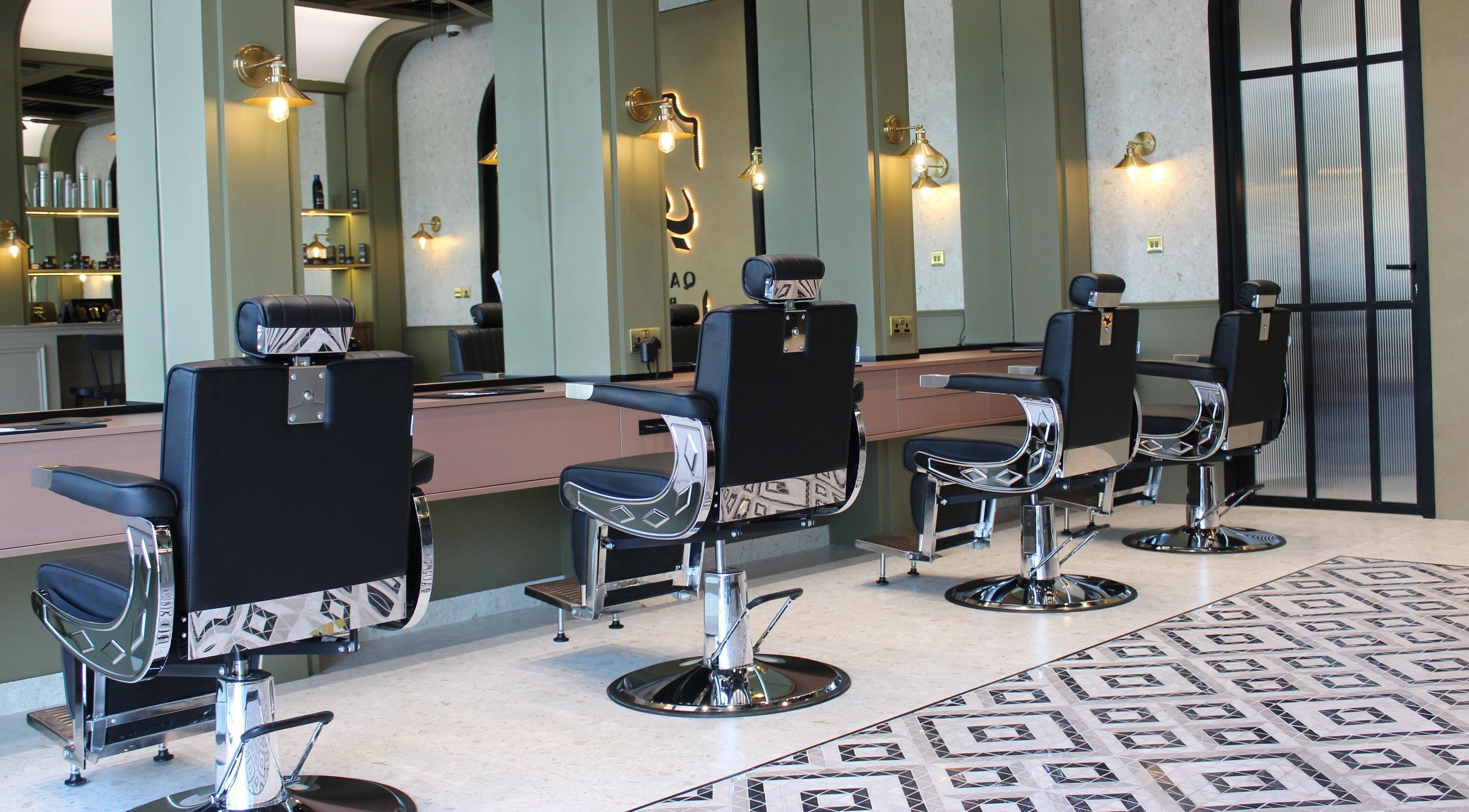 Modern barber chairs at Qabbani Barbers, Dubai, Dubai, AE, featuring sleek design and comfortable seating.