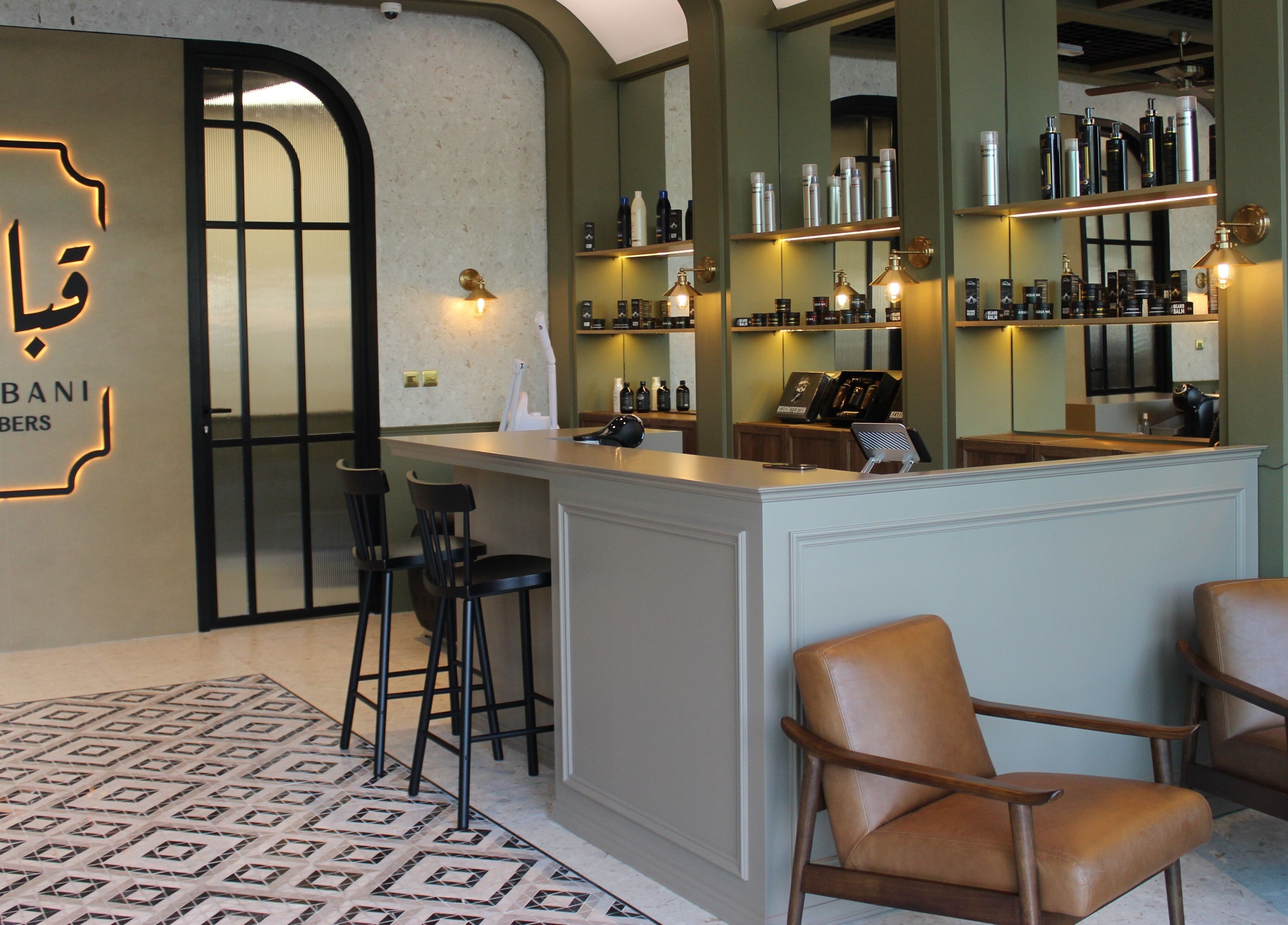 Elegant interior of Qabbani Barbers, Dubai, Dubai, AE with stylish chairs and grooming products on display.
