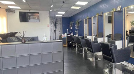 Modern salon interior at Strands of Perfection, Telford, England, GB, featuring stylish mirrors and chairs.