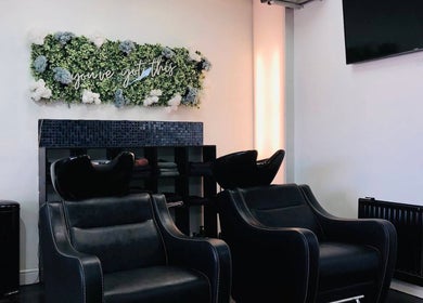 Sleek wash stations at Strands of Perfection, Telford, England, GB, enhance a modern salon vibe.