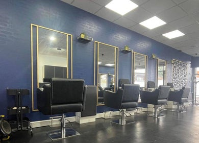 Chic interior of Strands of Perfection salon, Telford, England, GB, showcasing stylish mirrored stations.