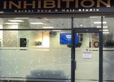 Modern salon facade of Strands of Perfection, Telford, England, GB under soft lighting.
