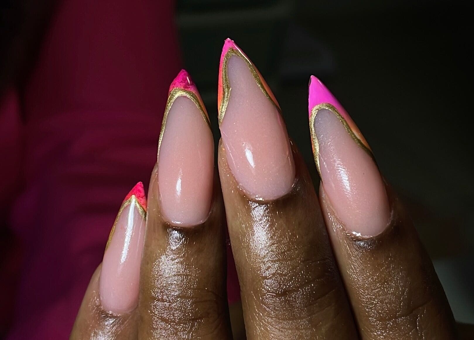 Bright pink and gold stiletto nails designed at Define Artistry Nail Bar, Gqeberha, Eastern Cape, ZA.