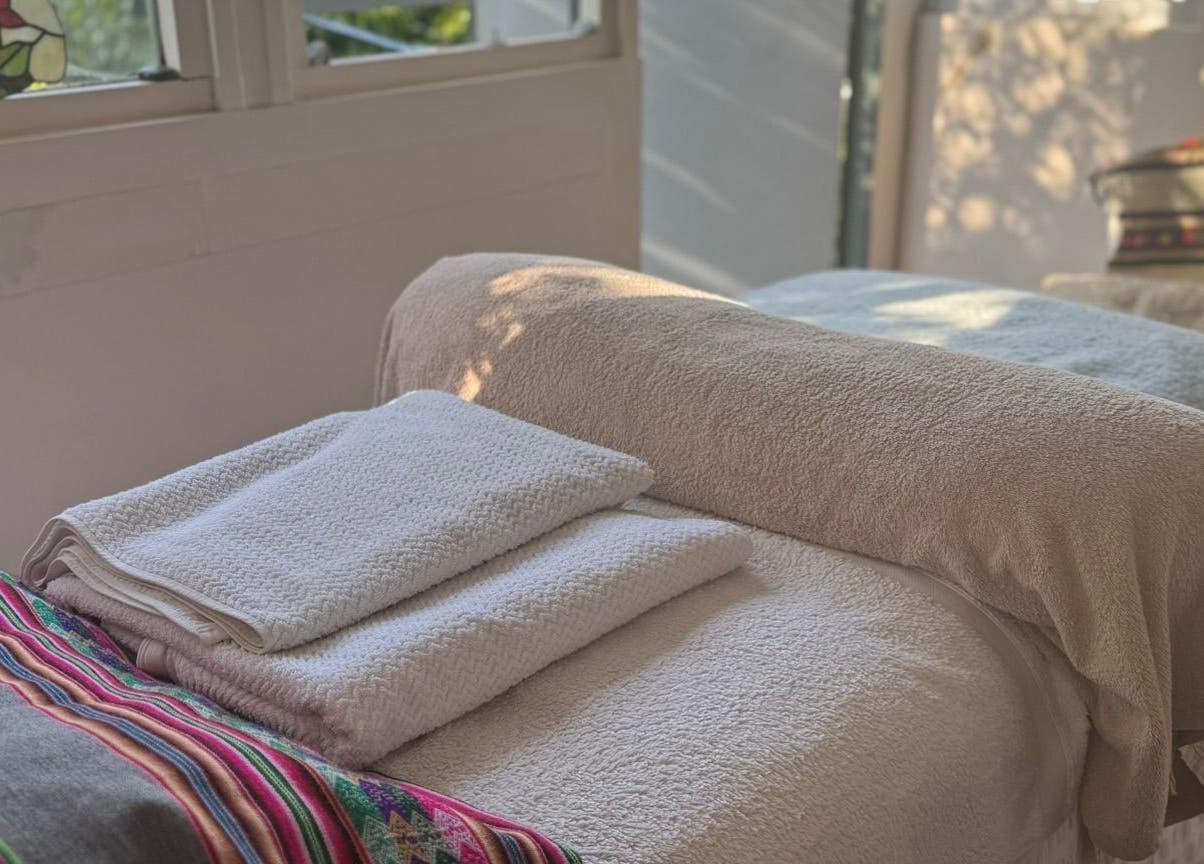 Peaceful massage room with towels at Rosie Atherton Wellbeing, Constantine, England, GB.