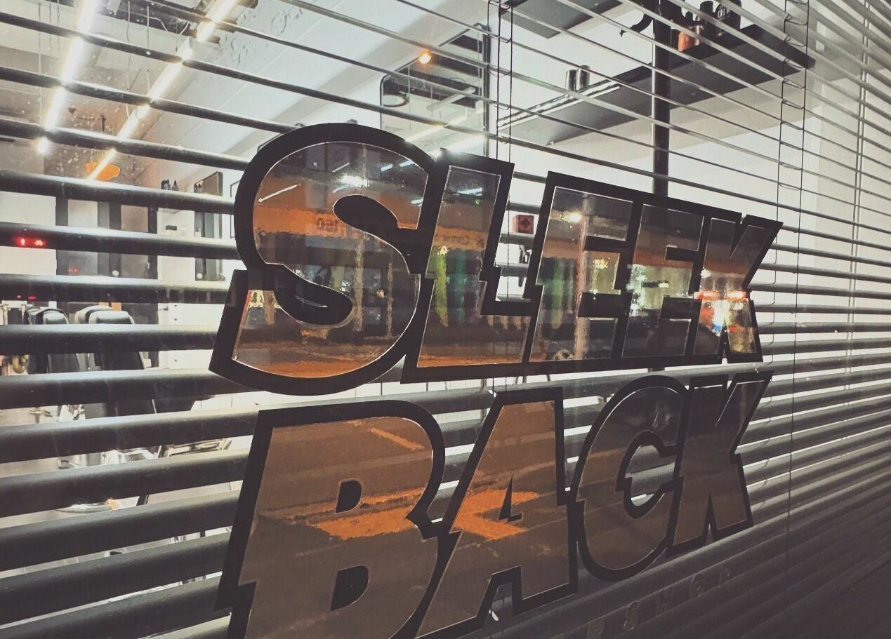 Sleek Back's stylish window reflects city lights in Melbourne, Victoria, AU.