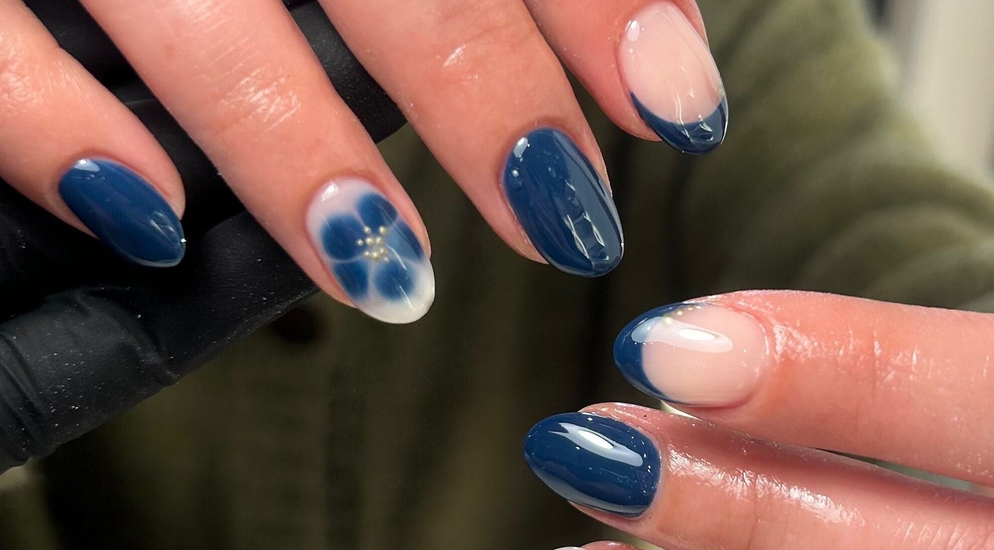 Stylish blue and floral nail design at Gracie May Beauty, Street, England, GB.