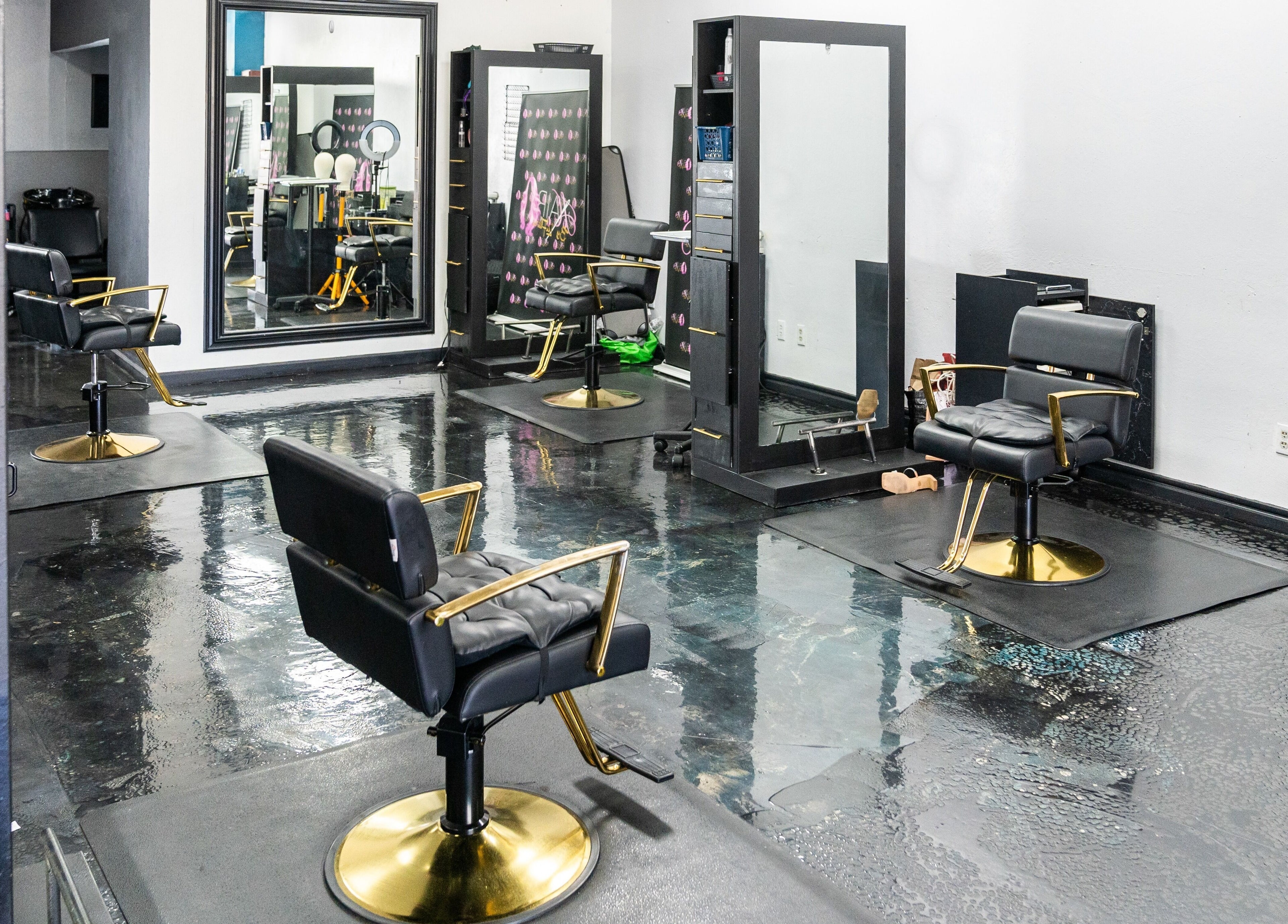 Elegant interior of Beauti Logic salon in Antioch, California, US featuring modern black and gold salon chairs.