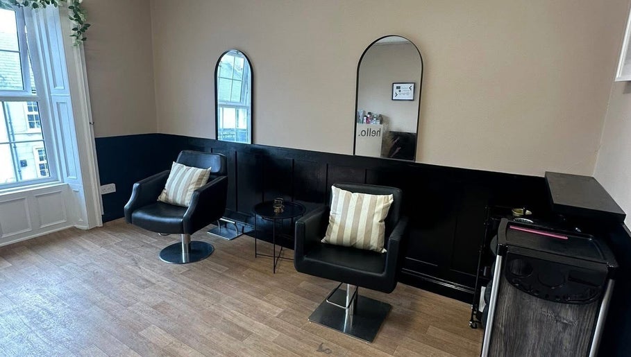 Chic seating area at Ashleigh Lauren Hair in Kircubbin, Northern Ireland, GB, featuring modern mirrors and chairs.