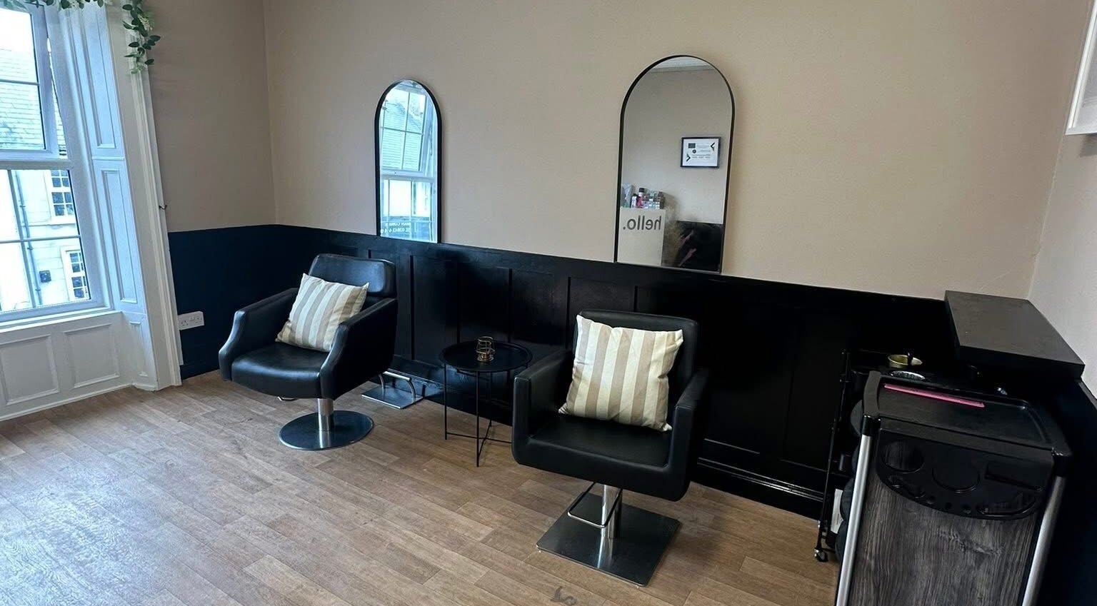 Chic seating area at Ashleigh Lauren Hair in Kircubbin, Northern Ireland, GB, featuring modern mirrors and chairs.