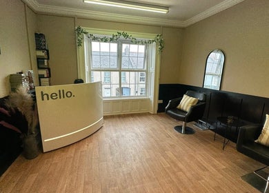 Reception area of Ashleigh Lauren Hair in Kircubbin, Northern Ireland, GB, featuring modern decor and seating.