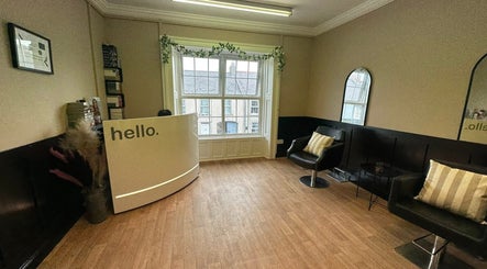 Reception area of Ashleigh Lauren Hair in Kircubbin, Northern Ireland, GB, featuring modern decor and seating.