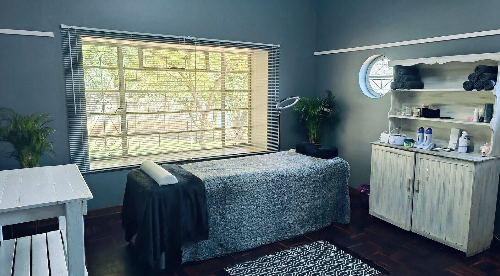 Calming spa space at Revive Hair Studio, Rustenburg, North West, ZA, featuring cozy massage table and serene decor.
