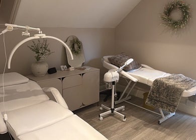 Luxelooks Porthcawl, Wales, GB, serene treatment room with plush massage tables and calming decor.