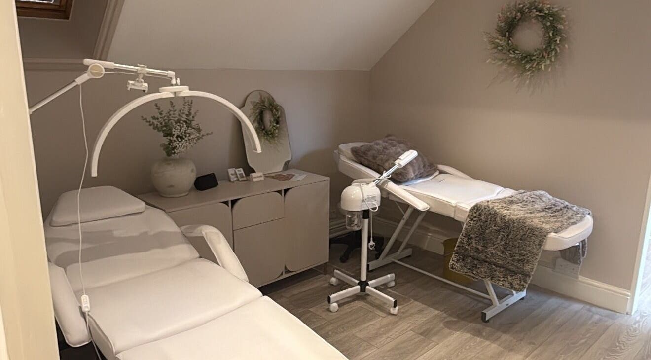 Luxelooks Porthcawl, Wales, GB, serene treatment room with plush massage tables and calming decor.