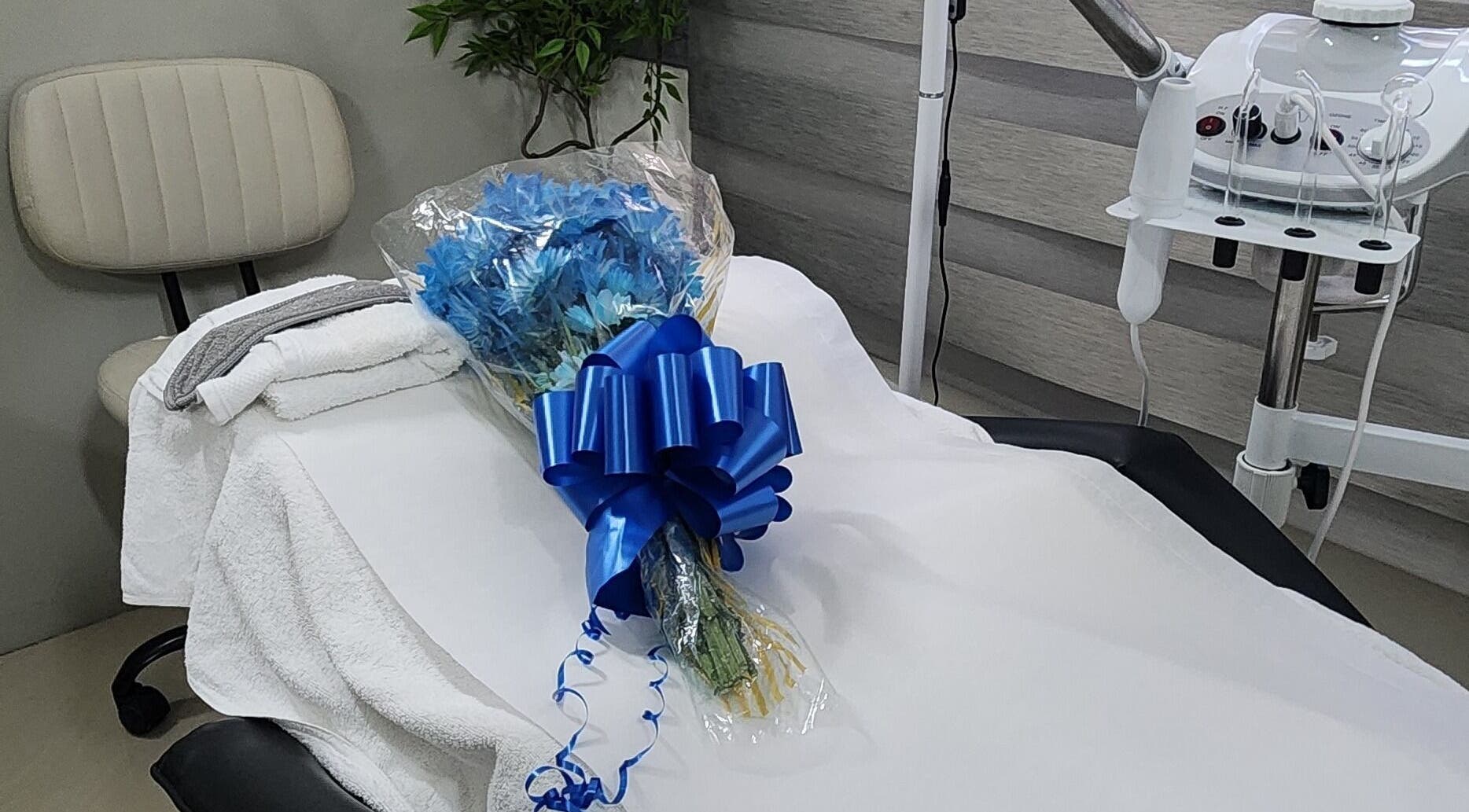 Zen Eden Lounge and Spa in Montego Bay, St. James Parish, JM. Treatment table adorned with blue flowers.
