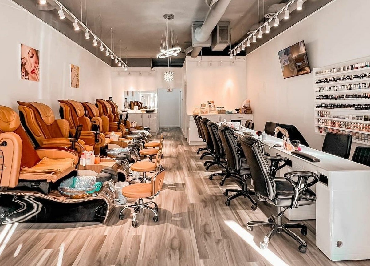 Luxurious interior of Lexi Nails & Spa in Airdrie, Alberta, CA featuring plush pedicure chairs and nail stations.