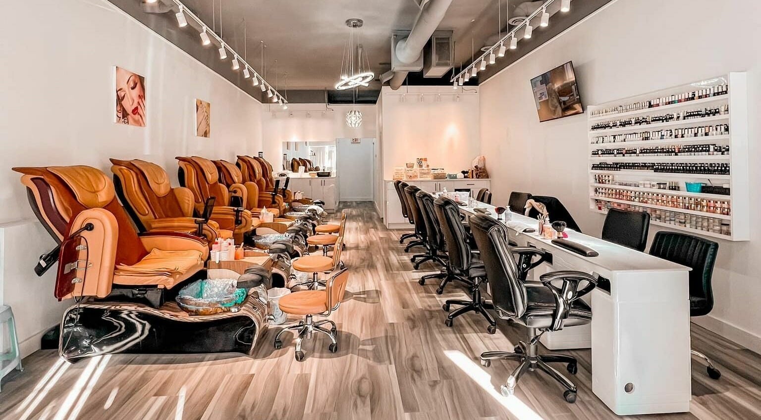 Luxurious interior of Lexi Nails & Spa in Airdrie, Alberta, CA featuring plush pedicure chairs and nail stations.