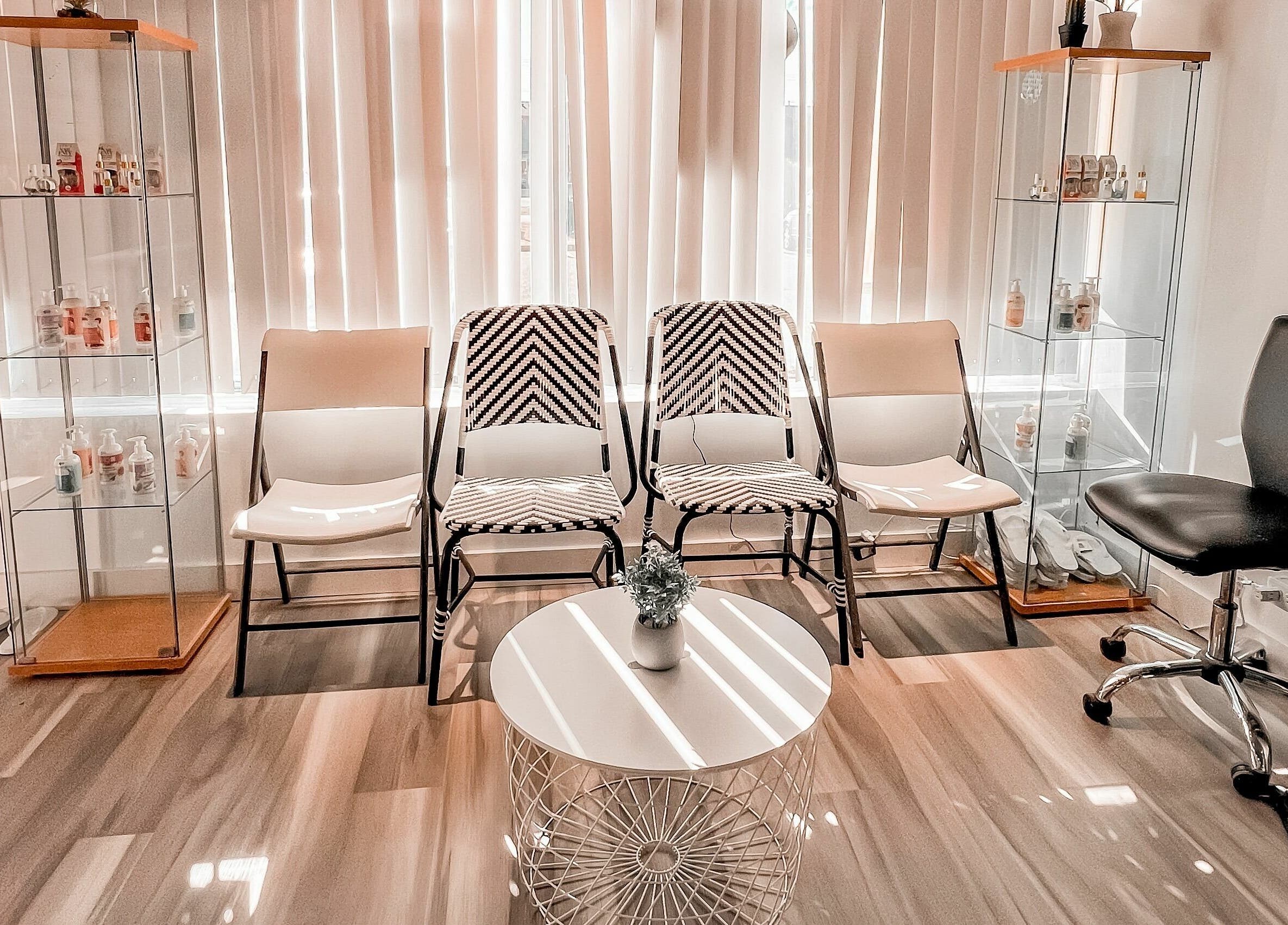 Elegant waiting area at Lexi Nails & Spa in Airdrie, Alberta, CA with modern chairs and decor.