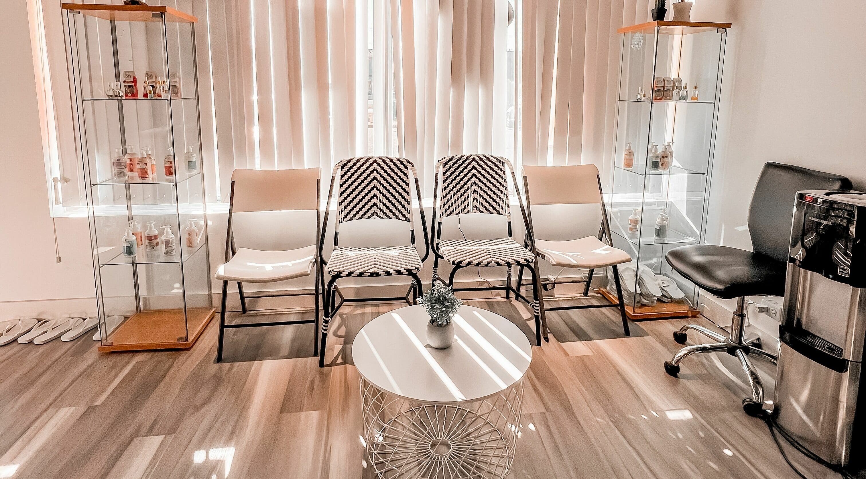 Elegant waiting area at Lexi Nails & Spa in Airdrie, Alberta, CA with modern chairs and decor.