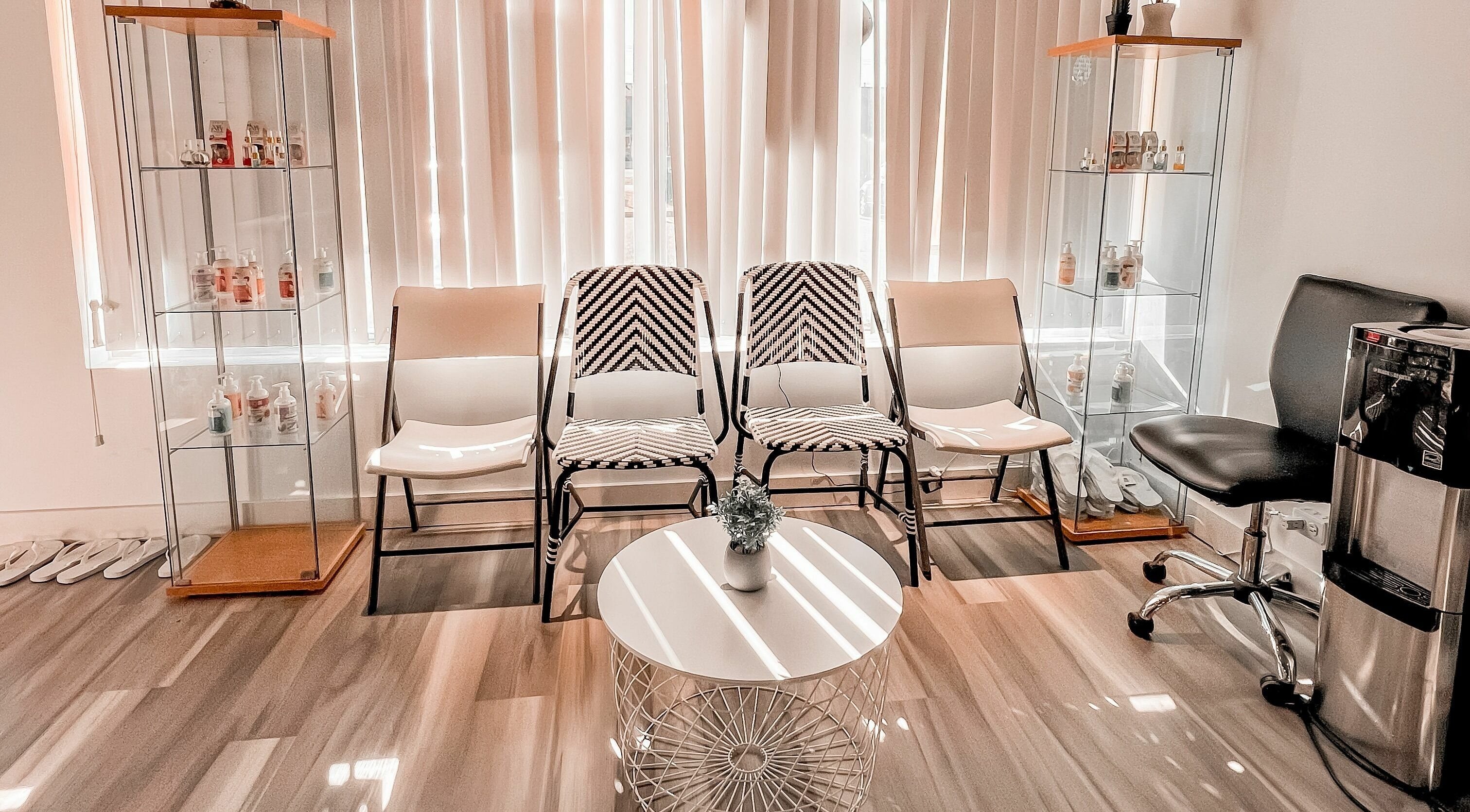 Elegant waiting area at Lexi Nails & Spa in Airdrie, Alberta, CA with modern chairs and decor.