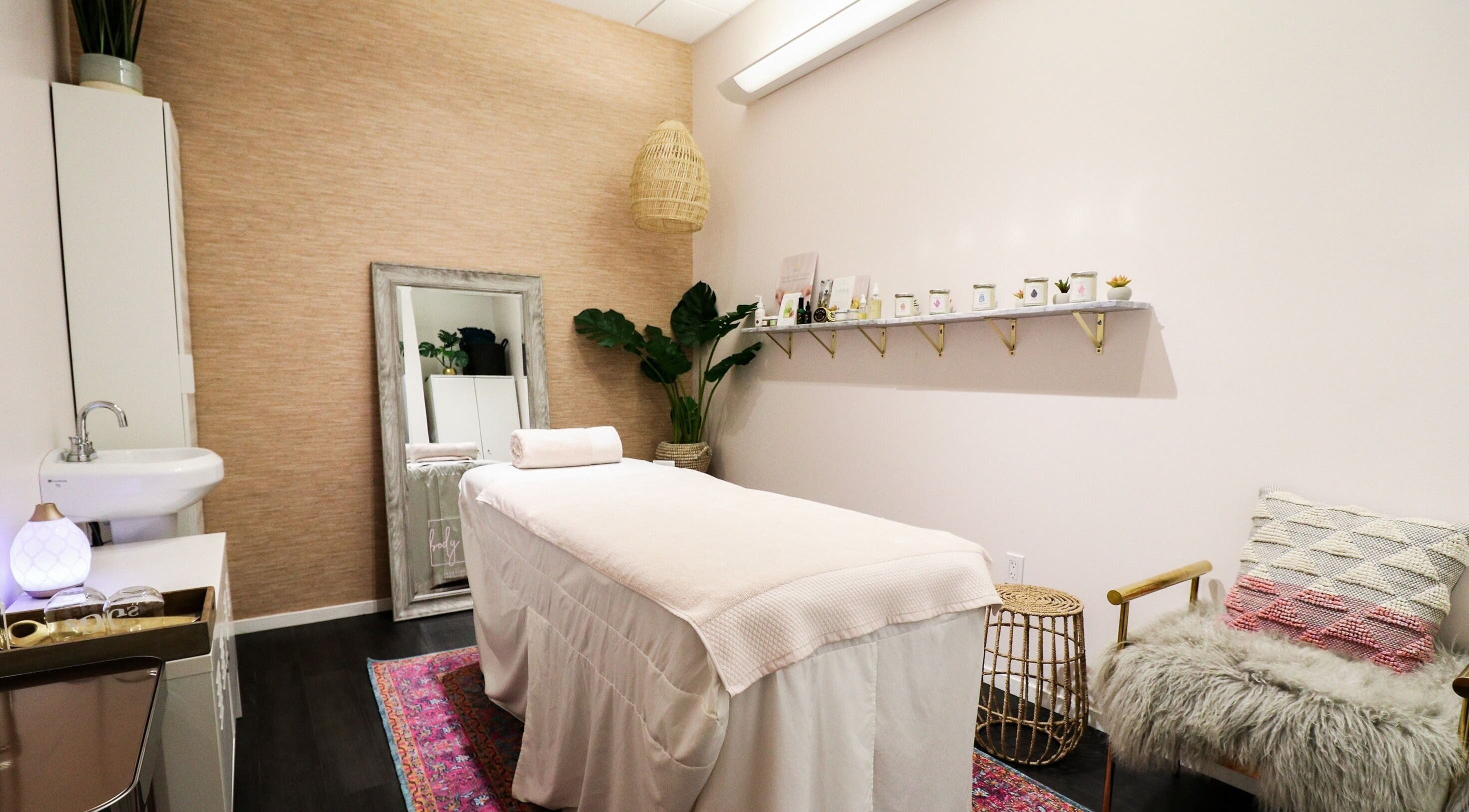 Cozy massage room at The Body Bungalow, Manhattan Beach, California, US, featuring a plush treatment table.