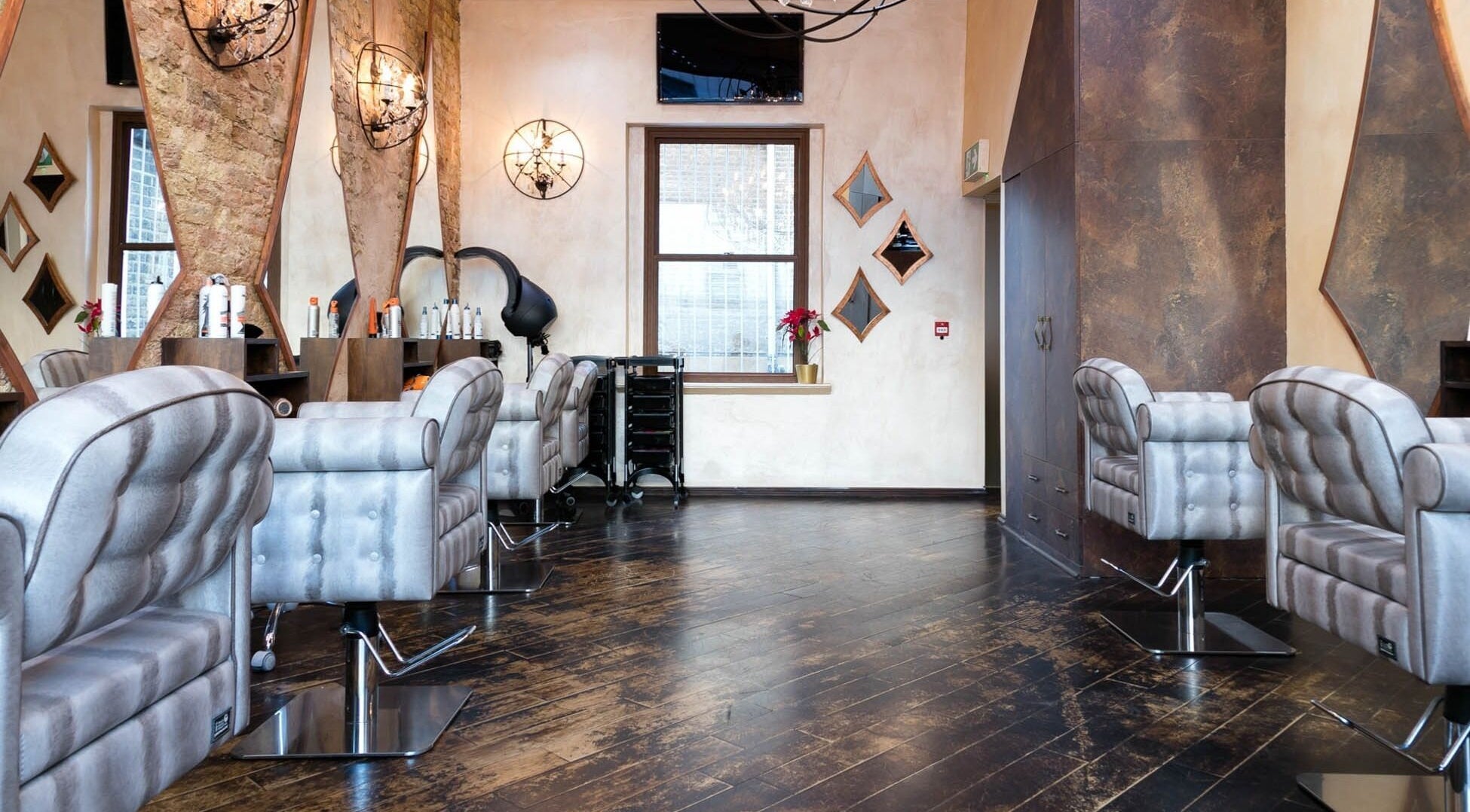 Modern salon interior at Twentuno Salon, London, England, GB, featuring plush chairs and stylish decor.