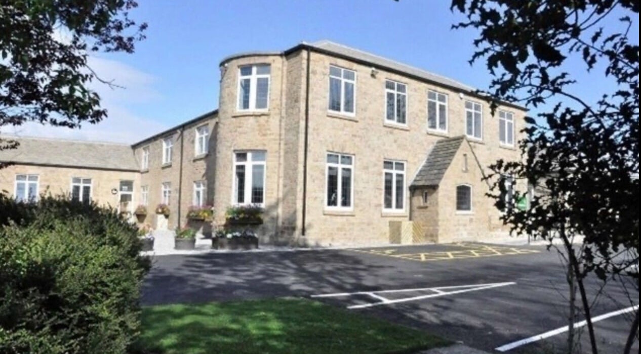 Scenic view of Inner Shine healing at Iveridge Hall, Oulton, England, GB, showcasing its elegant brick facade.