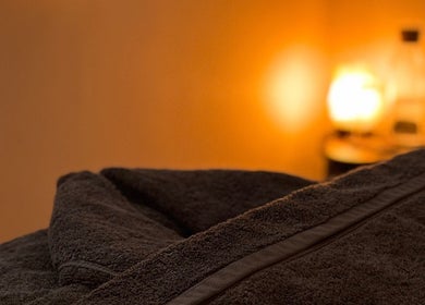 Warm ambiance at Rosie Holland Holistic Massage, Shipston-on-Stour, England, GB with soft lighting and plush towels.