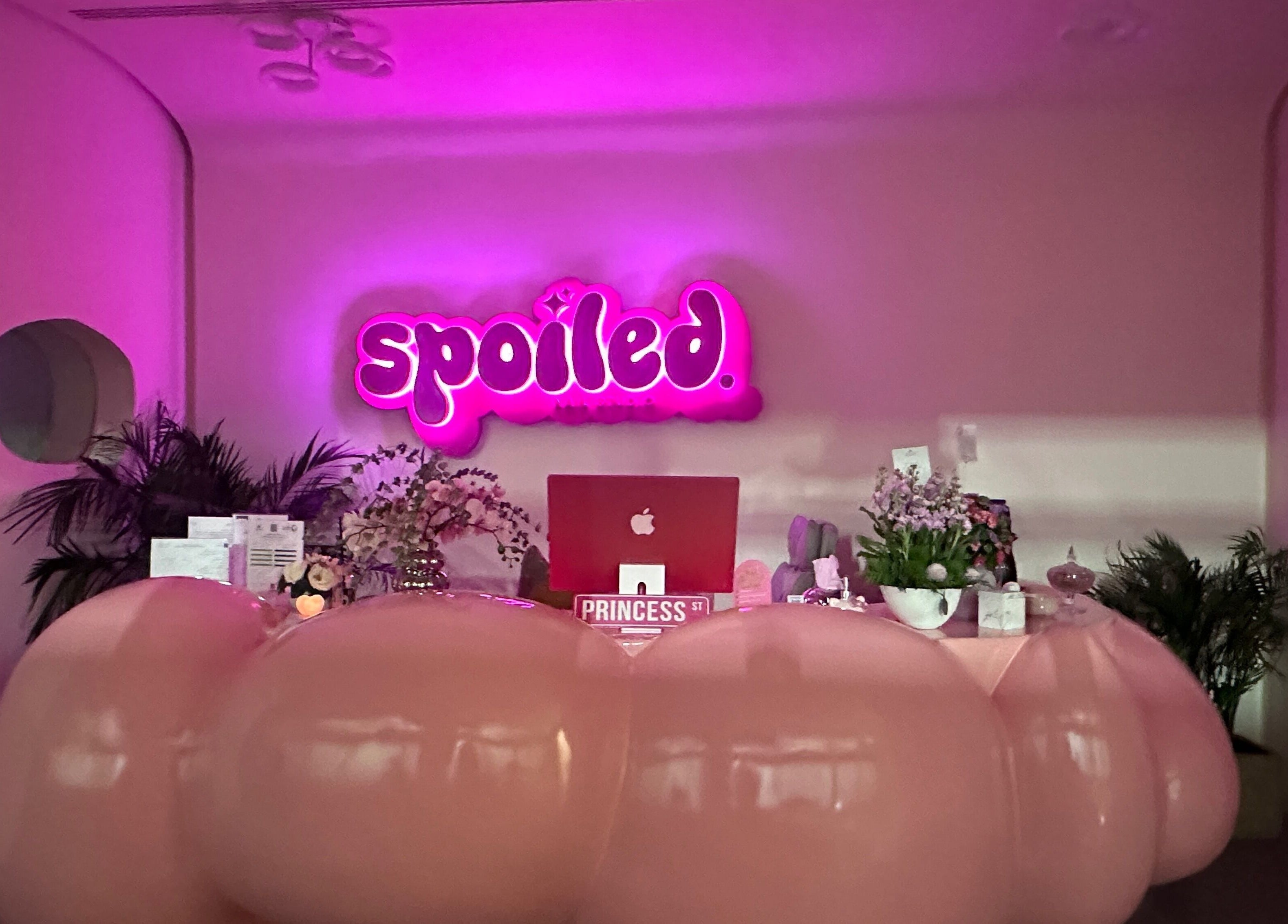 Stylish reception at Spoiled Nail Studio, Riyadh, Riyadh Province, SA with pink signage and modern decor.