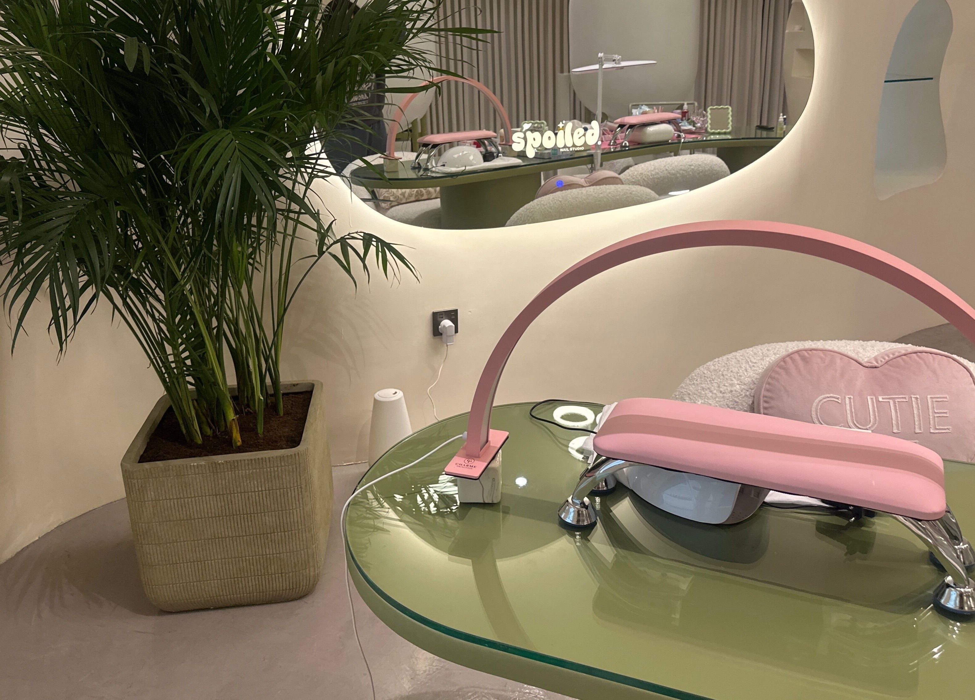 Modern nail station at Spoiled Nail Studio, Riyadh, Riyadh Province, SA, featuring a chic pink and green design.