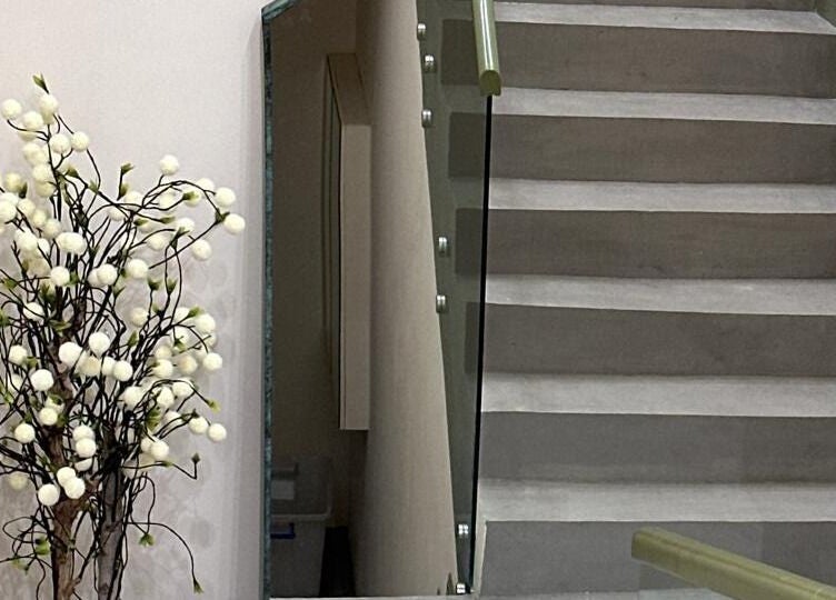 Elegant staircase with a white floral arrangement at Spoiled Nail Studio, Riyadh, Riyadh Province, SA.
