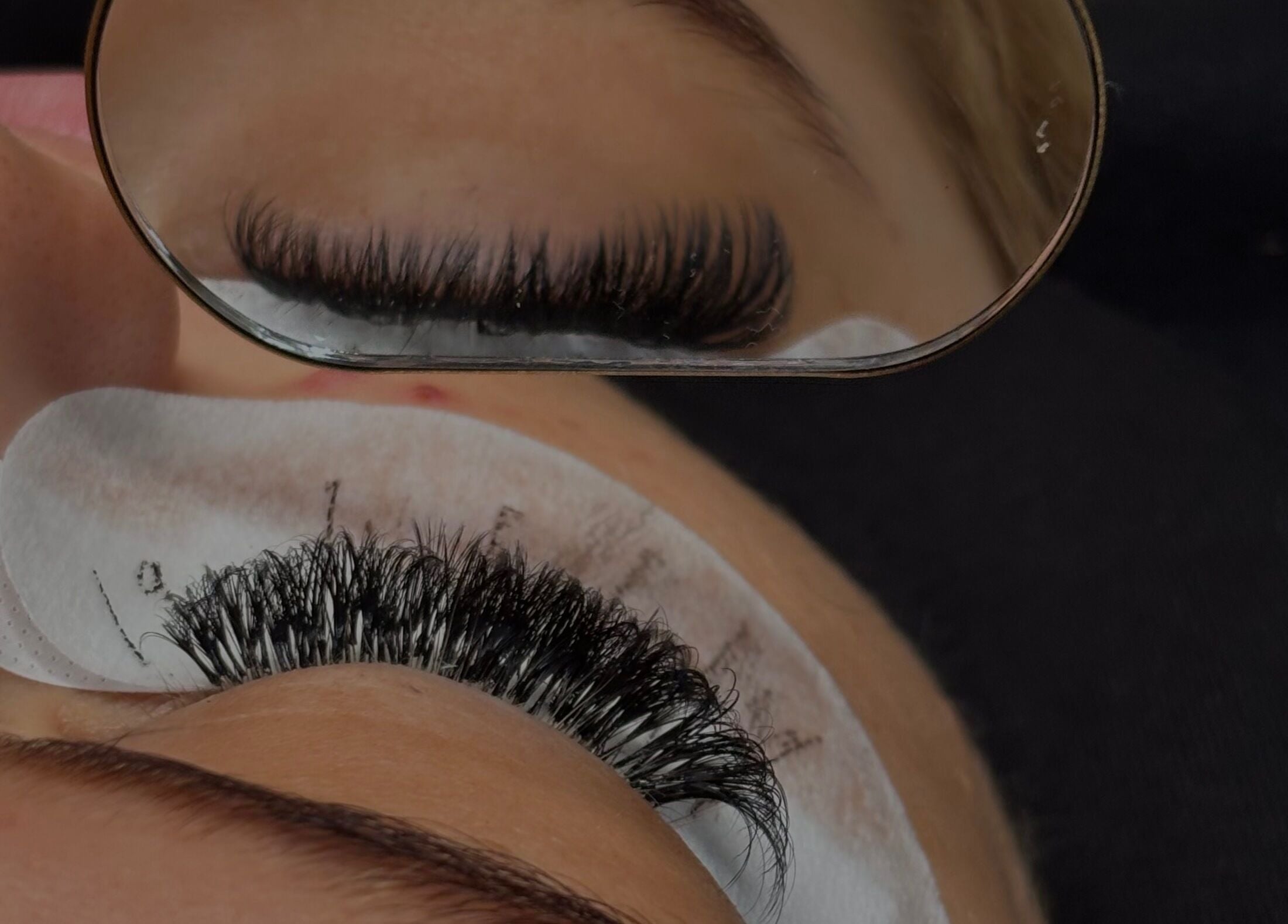 Close-up of eyelash extension application at Lily’s Luxè in Yaxley, England, GB.