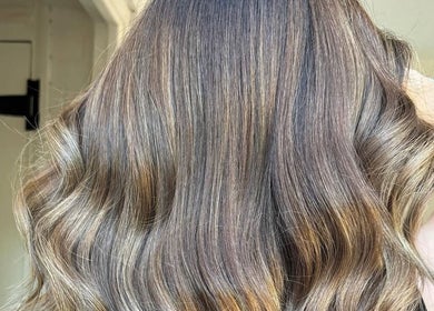 Radiant wavy hair styled at Hair by Natalie Blake, Kilndown, England, GB. Showcasing vibrant, healthy shine.