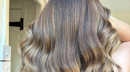 Radiant wavy hair styled at Hair by Natalie Blake, Kilndown, England, GB. Showcasing vibrant, healthy shine.