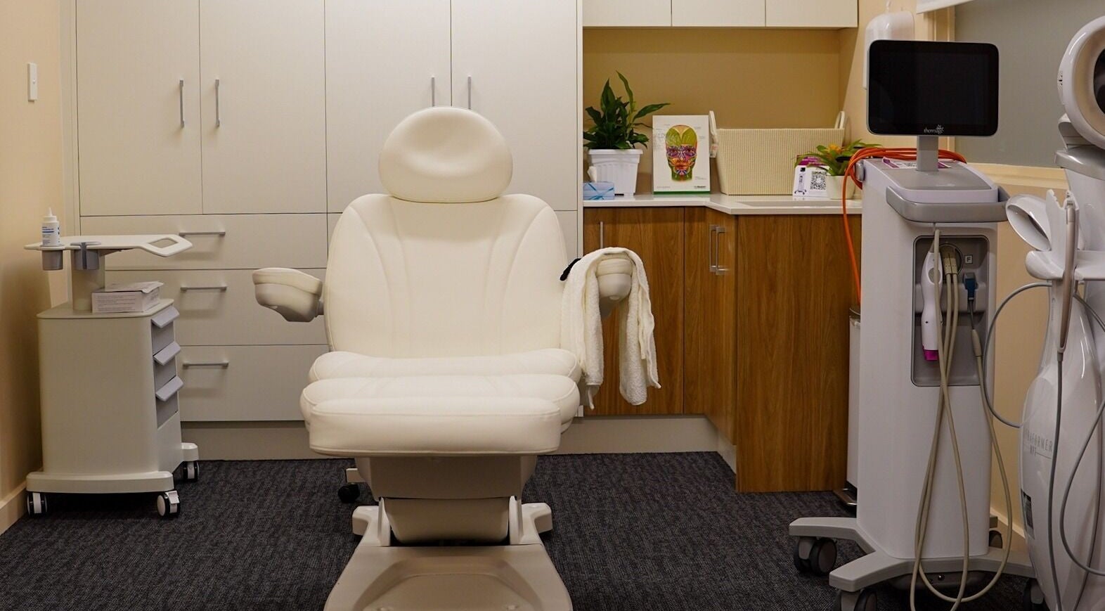 Modern treatment room at AK Pro Christchurch, Canterbury, NZ, featuring a comfortable chair and advanced equipment.