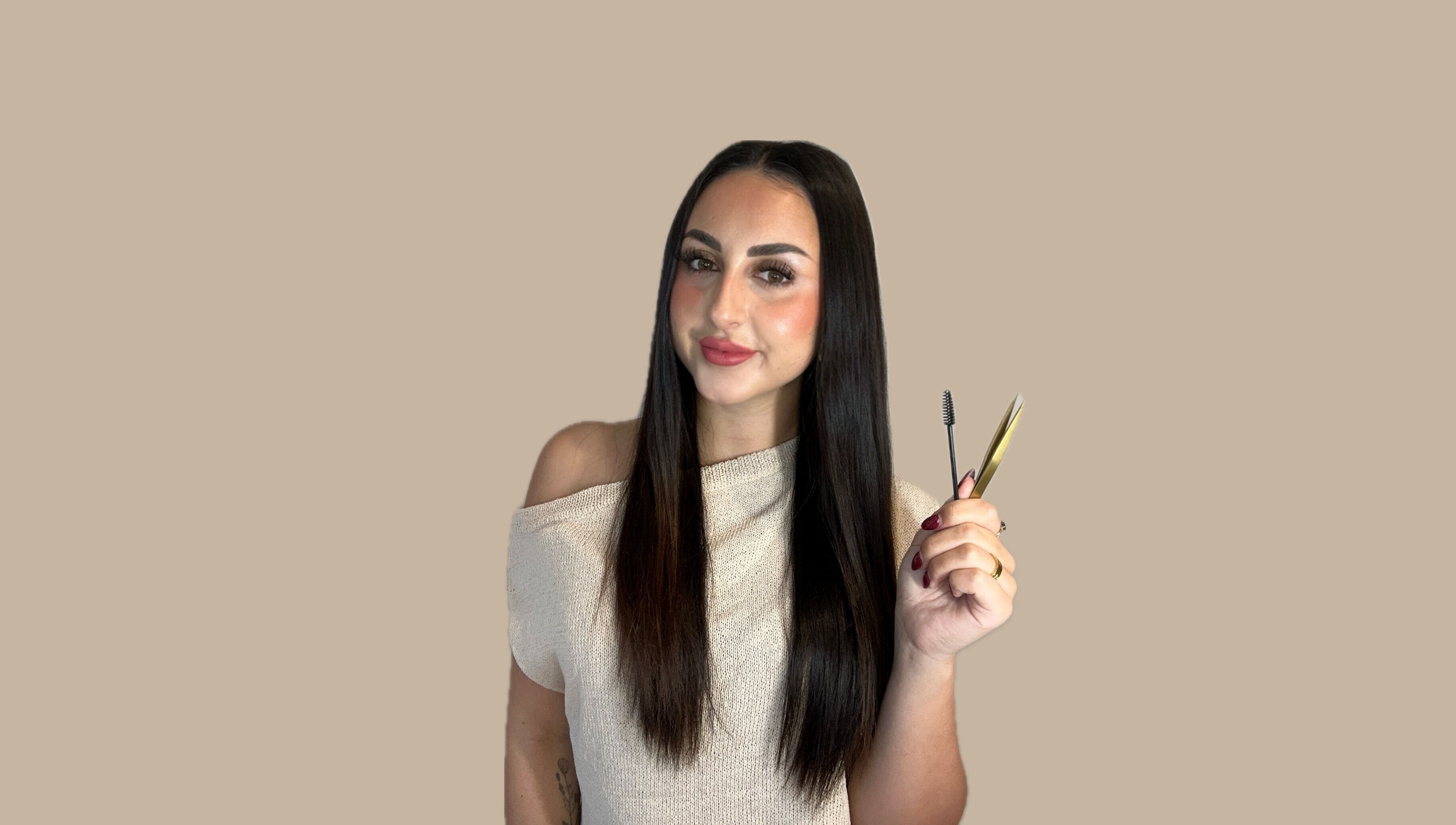 Makeup artist at Aesthetics By Hailee in Red Beach, Auckland, NZ holding beauty tools with confidence.